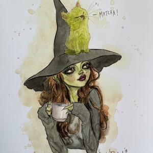 May include: Watercolor illustration of a green-skinned witch with brown hair wearing a black witch hat. A green cat sits on the hat, with the word "MATCHA!" written above it. The witch holds a white mug, and the artwork has coffee stain-like splatters.