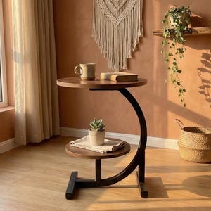 May include: A set of three ceramic mugs with a speckled, matte finish. The mugs are in shades of cream, light gray, and dark gray. Each mug has a simple, minimalist design and a rounded handle.