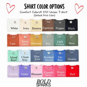May include: A display of Comfort Colors 1717 Unisex T-shirts in various colors, including white, ivory, banana, espresso, pepper, black, yam, terracotta, mustard, bay, light green, moss, island reef, chambray, blue jean, washed denim, flo blue, denim, orchid, violet, blossom, crunchberry, watermelon, and red. The text "SHIRT COLOR OPTIONS" is at the top.