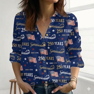 May include: Navy blue button-down shirt with a patriotic design. The shirt features American flags, stars, and the text "250 YEARS" and "Semiquincentennial" in gold and white. The long-sleeved shirt has a V-neck.