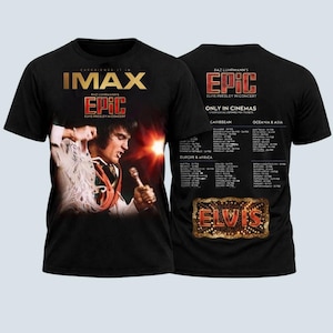 May include: Black t-shirt featuring a graphic of Elvis Presley performing, with the text "IMAX EPIC ELVIS PRESLEY IN CONCERT." The back of the shirt displays a list of cinema locations and the word "ELVIS" in a marquee style.