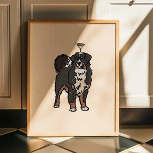 May include: A framed wall art print featuring a stylized illustration of a Bernese Mountain Dog with a martini glass balanced on its head. The dog has a black, white, and brown coat, and the artwork is set against a solid light beige background.