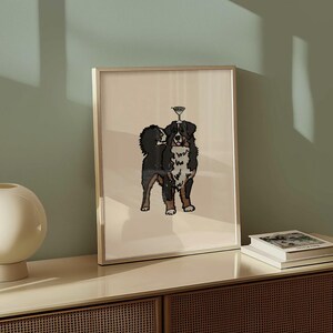 May include: A framed wall art print featuring a stylized illustration of a Bernese Mountain Dog with black, white, and brown fur. The dog is depicted standing and balancing a small martini glass on its head against a solid light beige background.