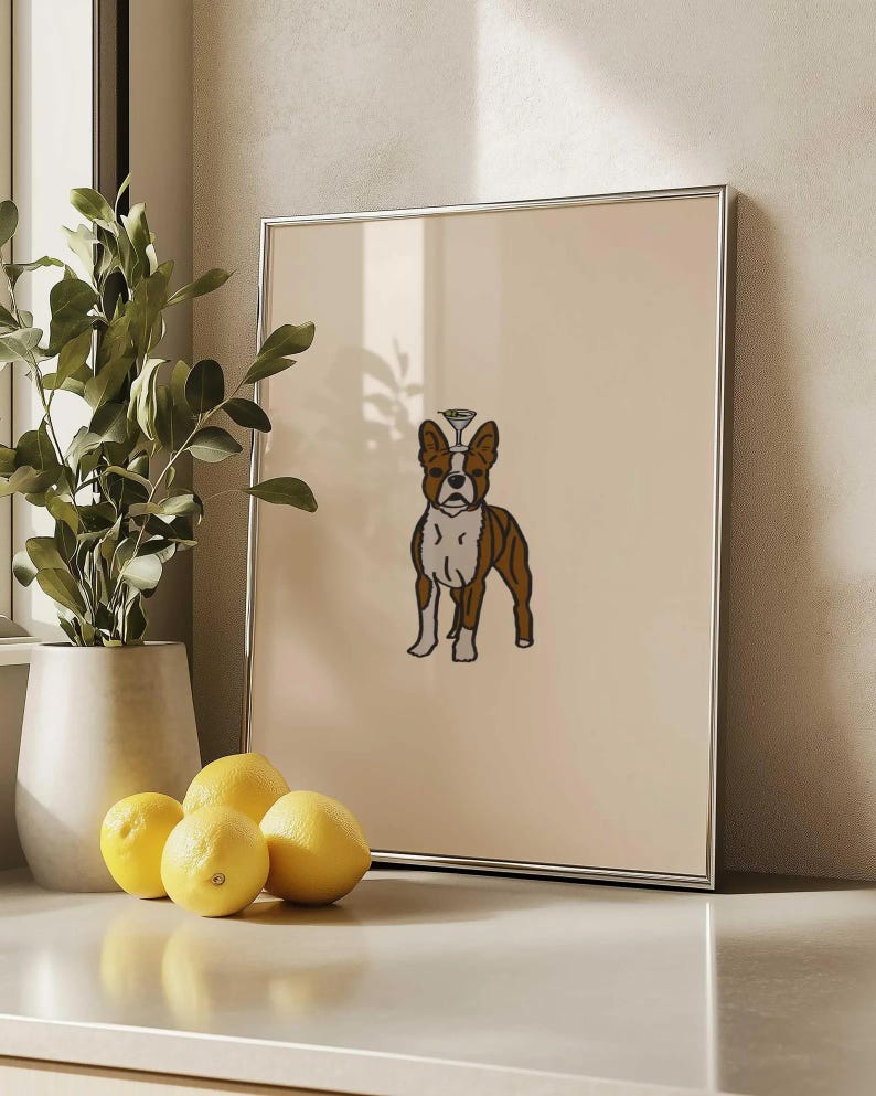 May include: A framed wall art print featuring a brown and white Boston Terrier dog illustration with a small martini glass balanced on its head, set against a solid light beige background within a thin silver metal frame.