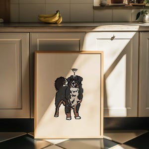 May include: A framed print featuring a stylized illustration of a Bernese Mountain Dog with a martini glass balanced on its head. The dog has black, white, and brown fur, and the artwork is set against a solid cream-colored background.