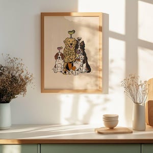 May include: A framed wall art print featuring a group of three dogs and one cat. The animals are illustrated in a cartoon style, with two dogs balancing small cocktail glasses on their heads. The background of the print is a solid light beige colour.