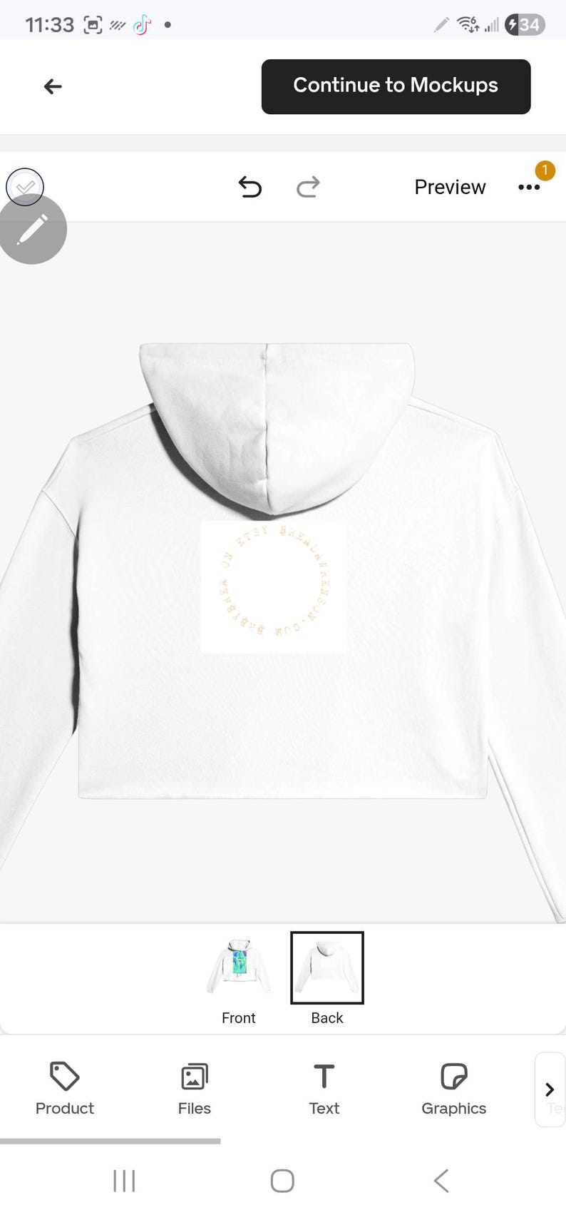 May include: White cropped hoodie with a hood. The back of the hoodie features a circular design with text. The hoodie is a casual garment, suitable for everyday wear. The design is centered on the back of the hoodie.