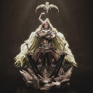 May include: A detailed figurine of a warrior with long, flowing blonde hair and ornate armour, holding two large black swords. A smaller figure with a crown hovers above. The base is a rocky structure, all set against a dark background.