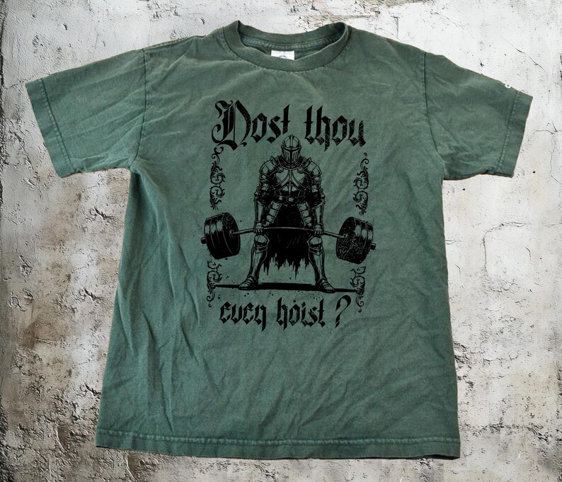 May include: Green t-shirt featuring the phrase "Dost thou even hoist?" and a black graphic of a knight lifting a barbell. The shirt has a crew neck and a vintage look.
