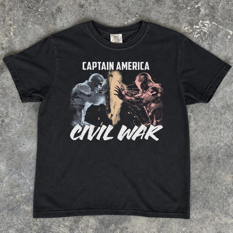 May include: Black t-shirt featuring the text "CAPTAIN AMERICA" above a graphic of two figures and the text "CIVIL WAR" in white. The graphic depicts a battle scene with figures in shades of blue and red.
