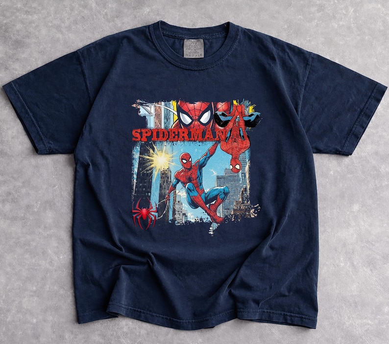 Puede incluir: Camiseta azul marino con un dise&ntilde;o de Spider-Man. El dise&ntilde;o presenta al superh&eacute;roe en rojo y azul, con la palabra "Spider-Man" en rojo. La camiseta est&aacute; hecha de un material suave.