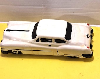 Vintage Ceramic car bank resembling a 1950s Cadillac or Pontiac Minister Delux style.