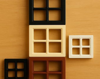 May include: An assortment of square, window-shaped decorative tiles in various colors: black, cream, brown, and white. Each tile features a grid pattern of four smaller squares, creating a window-like design. The tiles are arranged on a light brown wooden surface.