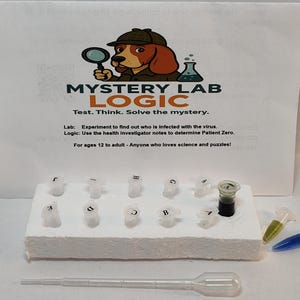 May include: A science-themed puzzle game with the text "MYSTERY LAB LOGIC". The image shows test tubes, a pipette, and a container with a dark liquid. The game is for ages 12 and up.