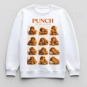 May include: White sweatshirt featuring a repeating pattern of cartoon monkeys hugging teddy bears. The word "PUNCH" is printed in orange above the pattern, with the text "Play Hard. Love Harder." below it.