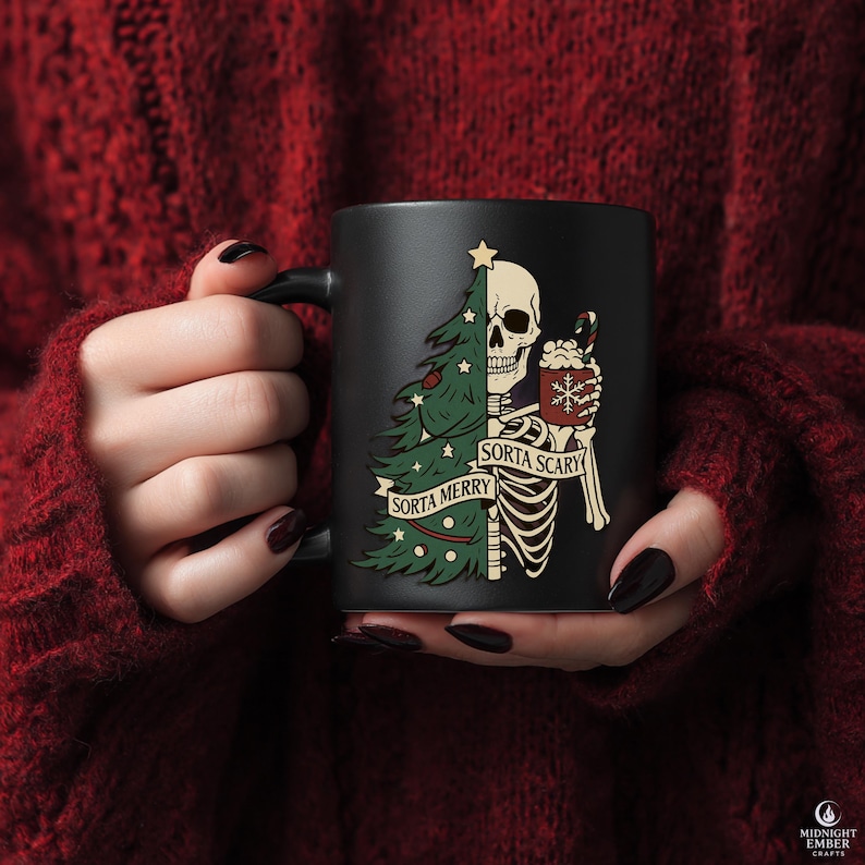 May include: Black ceramic mug featuring a skeleton with a Christmas tree design. The skeleton holds a mug with a snowflake design and the text "Sorta Scary" and "Sorta Merry". The mug has a black handle.