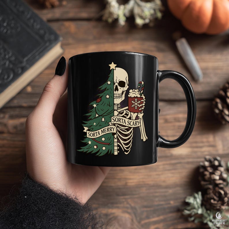 May include: Black ceramic mug featuring a skeleton design. One side shows a Christmas tree, the other a skeleton holding a hot beverage. Text reads "Sorta Merry" and "Sorta Scary".