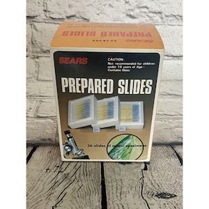 May include: A vintage Sears Prepared Slides box. The box is orange and black with the words "Prepared Slides" in large white letters. The box contains 36 slides of actual specimens. A caution is printed on the box: "Not recommended for children under 10 years of Age - Contains Glass."