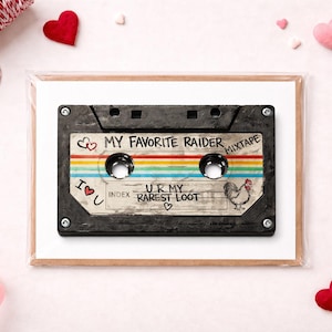 May include: A greeting card featuring a vintage cassette tape design with the text "My Favorite Raider Mixtape." The tape has a rainbow stripe and a rooster illustration. Pink and red hearts and ribbon surround the card.