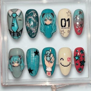 May include: A set of ten artificial nails with various designs. The designs include a suit and tie, glitter, a cartoon character, the number "01" with stars, a binary code, a hand holding a phone, and a smiley face.