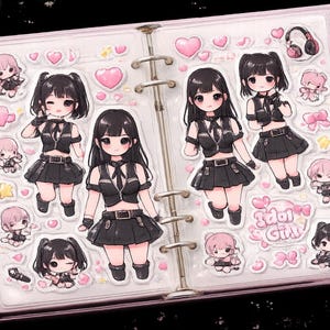 May include: A pink binder filled with stickers featuring anime-style characters in black outfits, hearts, and the text "Idol Girl". The stickers are in a variety of poses and sizes, with pink and black accents.