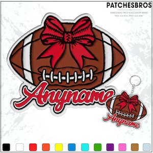 May include: Embroidered patch and keychain set featuring a football design with a red bow. The patch and keychain have the text "Anyname" in red script. The football is brown with white stripes and stitching.