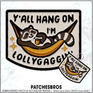 May include: Embroidered patch featuring a raccoon relaxing in a hammock, with the text "Y'all Hang On I'm Lollygaggin'". The patch is rectangular with a black border, and includes a smaller keychain version.