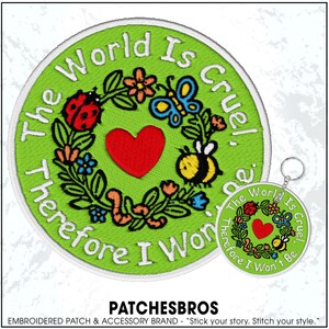 May include: Embroidered patch and keychain set with the text "The World Is Cruel, Therefore I Won't Be." The patch features a green background with a floral wreath, a red heart, and cartoon insects. The keychain mirrors the patch design.