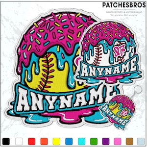 May include: Embroidered patches with a baseball theme, featuring a baseball design with pink frosting and sprinkles. The patches have the text "ANYNAME" in white. A keychain with a similar design is also included.