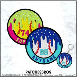 May include: Embroidered baseball patches and a keychain. The patches feature a baseball design with a dripping effect in various colors, including yellow, pink, and blue. The text "74 SOP" and "98 ANYNAME" are visible. The keychain mirrors the design.