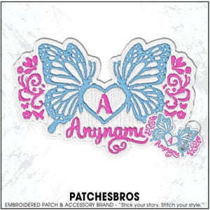 May include: An embroidered patch and matching keychain featuring a central heart with the letter A, flanked by light blue butterfly wings and pink floral scrollwork. The text Anyname is stitched in pink below the heart on both items.