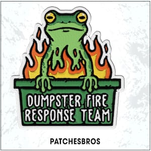 May include: Embroidered patch featuring a green frog with yellow eyes, sitting in a green dumpster with flames. Text reads "DUMPSTER FIRE RESPONSE TEAM". The patch also includes the text "PATCHESBROS".