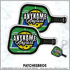 May include: Embroidered patches and a keychain featuring a pickleball paddle design. The patches and keychain have a green, blue, and yellow color scheme with the text "ANYNAME Anylext". The patches have a black handle and white border.