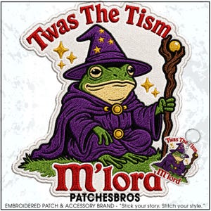 May include: An embroidered patch featuring a green frog dressed as a wizard in a purple robe and hat, holding a wooden staff with a yellow orb. The text reads Twas The Tism and M'lord in red. A smaller matching keychain is also visible.