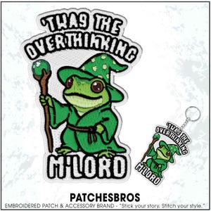 May include: Embroidered patch and keychain featuring a green frog wizard with the text "THAS THE OVERTHINKING M'LORD". The frog wears a green hat and robe, holding a staff with a green orb. The brand name "PATCHESBROS" is at the bottom.
