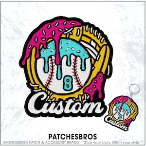 May include: Embroidered patch and keychain featuring a baseball design with a donut-like topping in pink and blue. The baseball has the number 8 and the word "Custom" in white. The patch is yellow, white, pink, and blue.