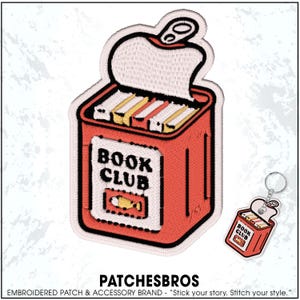 May include: Embroidered patch and keychain set featuring a red can design with the words "BOOK CLUB" on the front. The can is open, revealing stacks of books. The keychain mirrors the patch design.