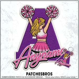 May include: An embroidered patch featuring a large purple letter A with a cheerleader in a pink and white uniform holding pink and white pom-poms. The word Anyname is written in pink script across the front. A smaller matching keychain is also shown.