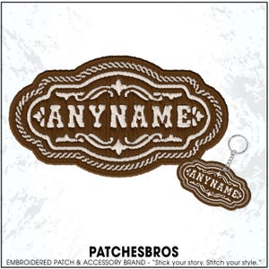May include: A brown embroidered patch and keychain with the text "ANYNAME" in white. The patch has a decorative border and floral accents. The keychain is a smaller version of the patch. The brand name "PATCHESBROS" is at the bottom.