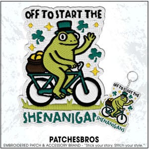 May include: Embroidered patch featuring a green frog riding a bicycle, wearing a top hat, and carrying a pot of gold. The text "OFF TO START THE SHENANIGANS" is above and below the frog. A matching keychain is also shown.