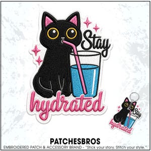 May include: An embroidered patch and matching keychain featuring a black cat with large yellow eyes drinking blue water from a glass with a pink straw. The design includes pink star accents and the text Stay hydrated in black and pink script.