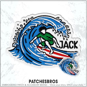 May include: An embroidered patch and a matching keychain featuring a surfer in a green shirt riding a large blue wave on a red and white surfboard. The design includes the name JACK in black lettering next to the wave on a white background.