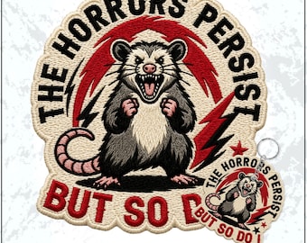 May include: An embroidered patch and a matching circular keychain featuring a snarling opossum with clenched fists. The design includes red lightning bolts and the text THE HORRORS PERSIST BUT SO DO I in black and red thread on a cream background.