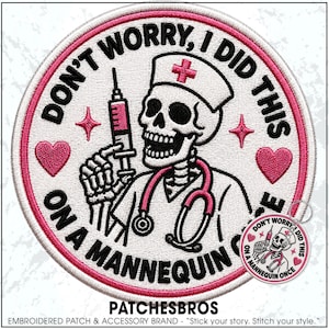 May include: A circular embroidered patch featuring a skeleton dressed as a nurse with a stethoscope and syringe. The text reads DON'T WORRY, I DID THIS ON A MANNEQUIN ONCE. The design includes pink hearts and stars on a white background with a pink border.