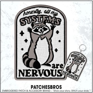 May include: Embroidered patch and keychain featuring a raccoon with the text "honestly, all my SYSTEMS are NERVOUS." The patch is gray, black, and white, with a raccoon design. The keychain has a similar design.