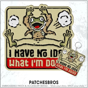 May include: Embroidered patch and keychain set featuring a cartoon frog with the text "I Have No Idea What I'm Doing." The frog is depicted with its arms and legs spread wide. The patch and keychain have a tan background with a red border.