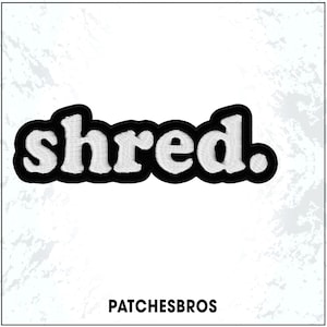 May include: Embroidered patch with the word "shred" in white, outlined in black. The patch has a rounded, bubble-letter style. The text "PATCHESBROS" is printed in black at the bottom of the image.
