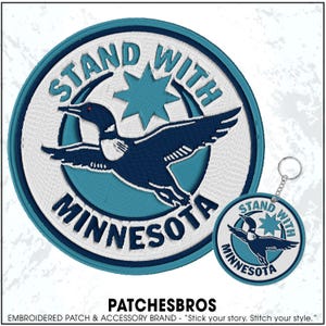 May include: Embroidered patch and keychain featuring a loon in flight, with the text "STAND WITH MINNESOTA." The design includes a teal star and a circular border. The patch and keychain are white, teal, and navy blue.