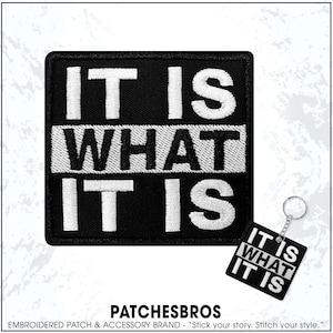 May include: Black square patch and keychain with the phrase "IT IS WHAT IT IS" embroidered in white. The patch and keychain are from the brand PATCHESBROS.