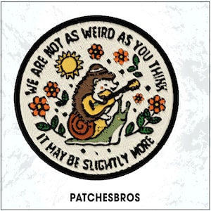May include: Embroidered patch with a whimsical design. A hedgehog plays a guitar while riding a snail, surrounded by orange flowers and a sun. Text reads "WE ARE NOT AS WEIRD AS YOU THINK, IT MAY BE SLIGHTLY MORE". The brand name "PATCHESBROS" is at the bottom.